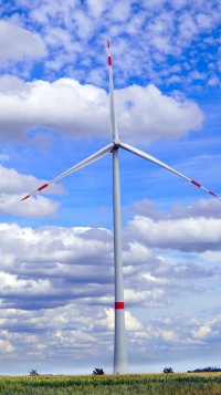 Eine Windanlage mit einem Windrad vor einer anschaulichen Landschaft