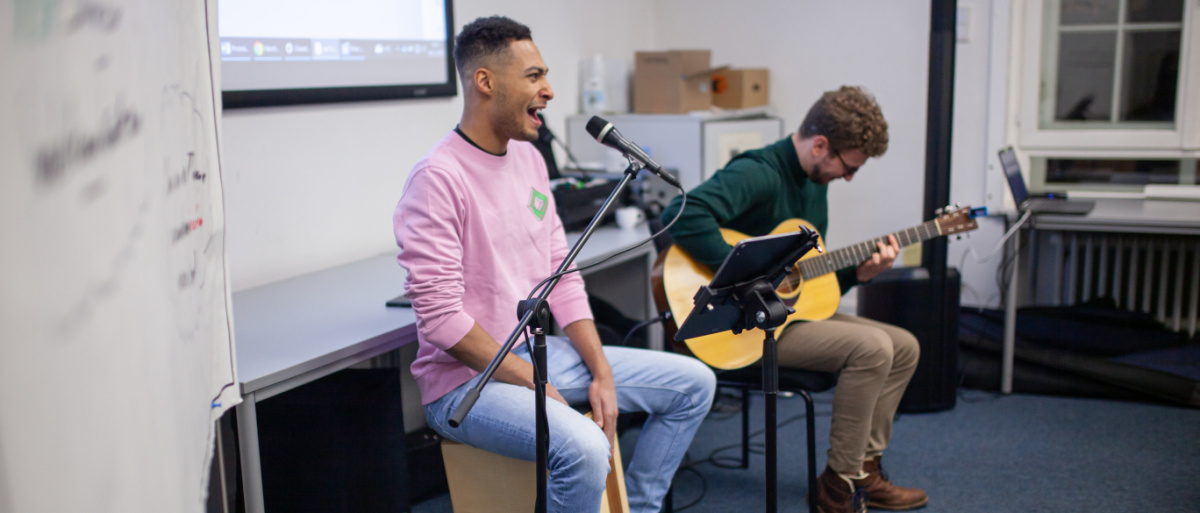 Justin Hayo und ein weiterer Musiker spielen Songs bei der Demokratiekonferenz